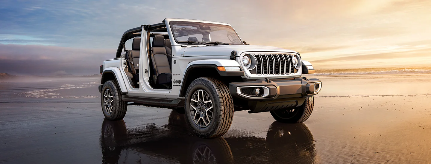 a white 2026 Jeep Wrangler on a beach with doors off