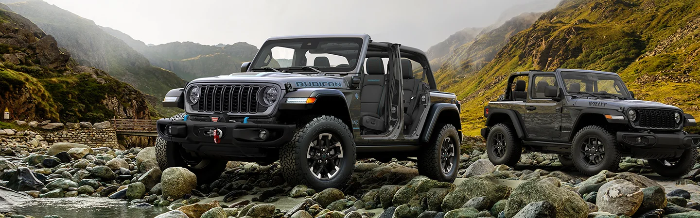 2 gray 2026 Jeep Wrangler parked on rocks