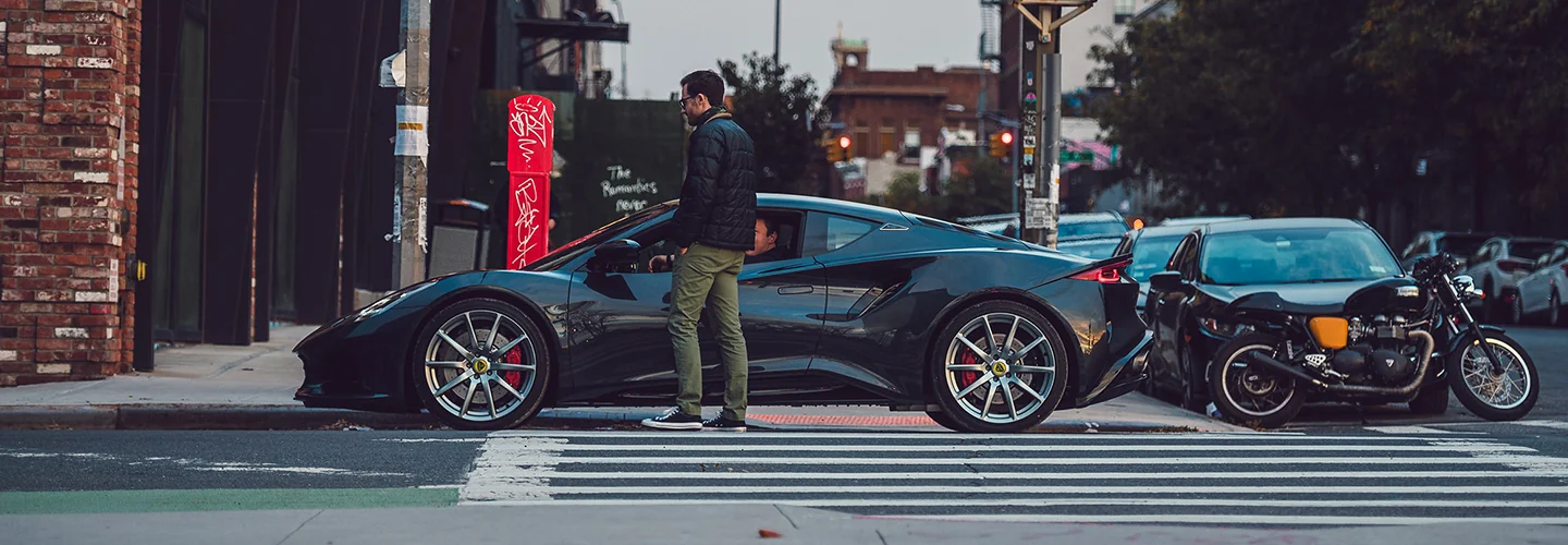 Side view of a parked Exotic car on a city street