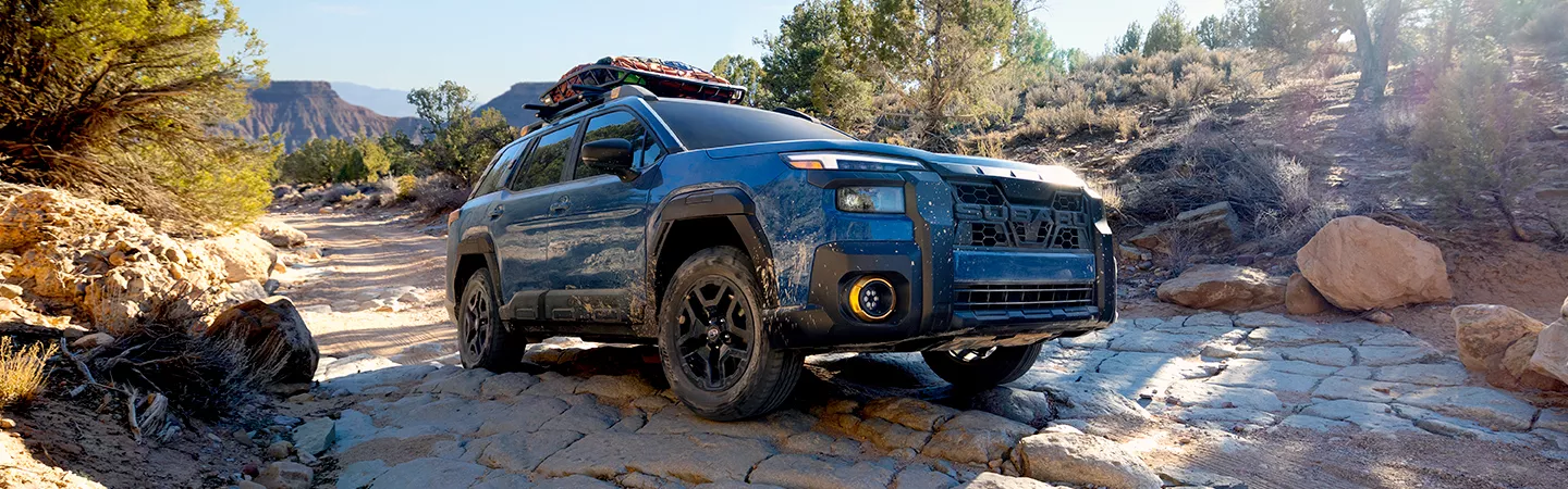 2026 Subaru Outback Wilderness driving through a rocky road