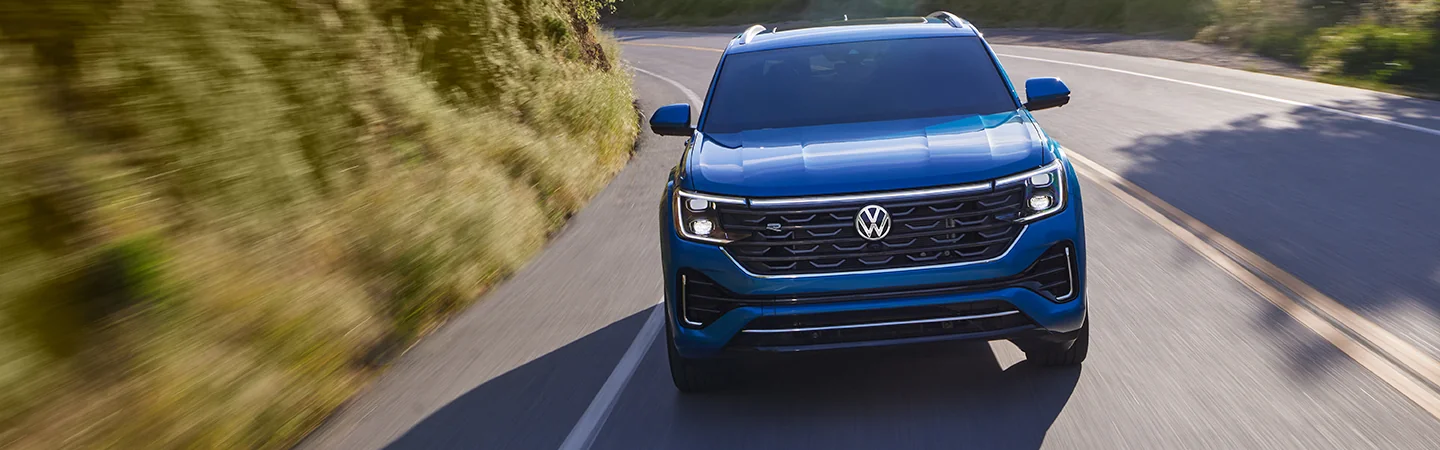 a front view of an in motion blue 2026 Atlas Cross Sport