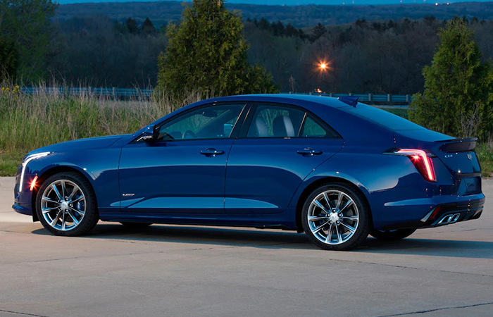 Rear driver side view of a blue CT4 in motion