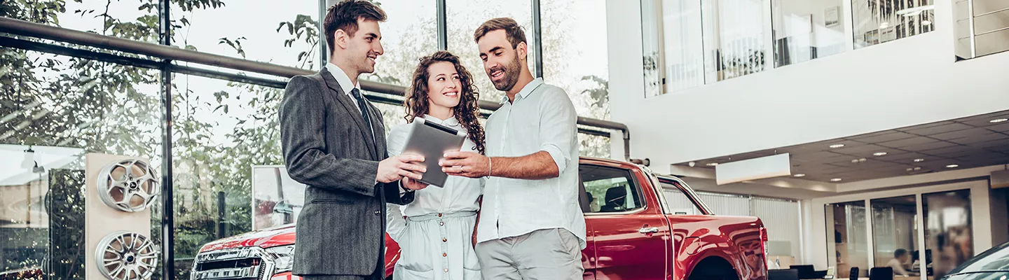 Car salesperson speaking with customers at Jerry Ulm CDJR