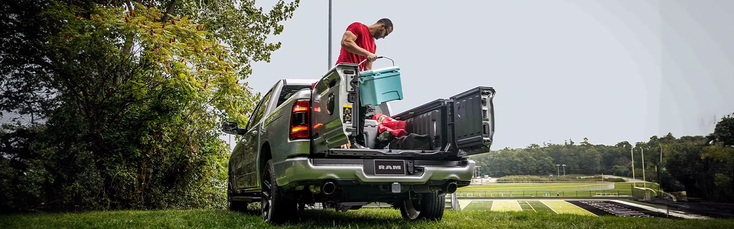 2024 RAM 1500 vs Chevrolet Silverado silver color back view