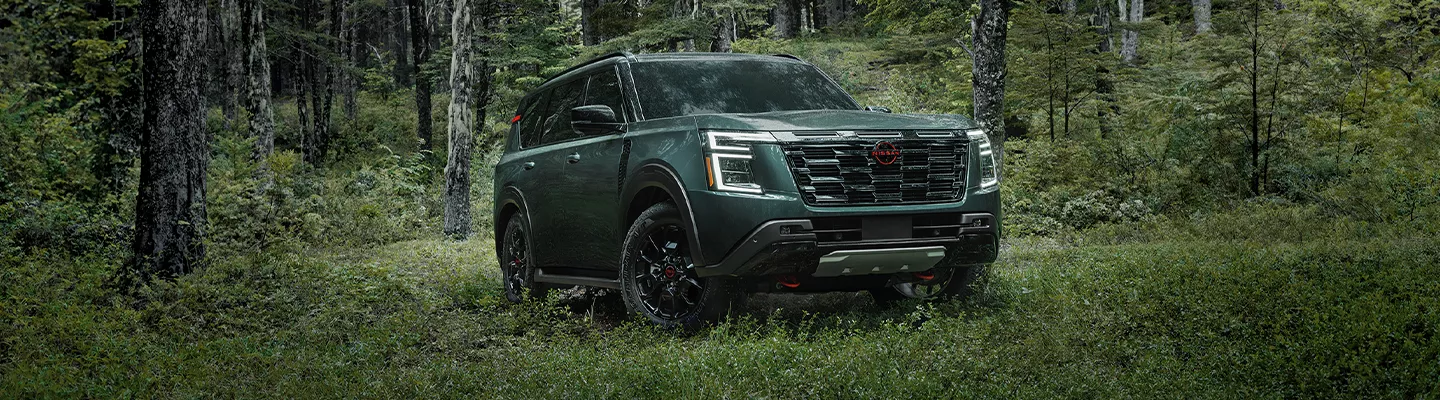2026 Nissan Armada parked in thick forest scene