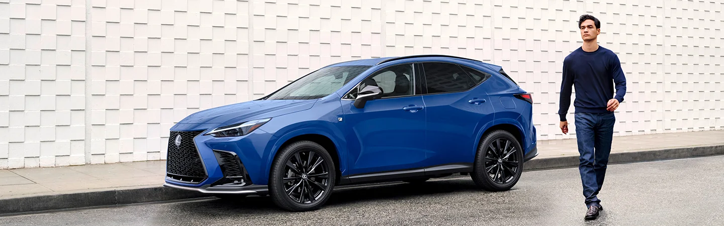 Side view of a blue parked 2026 Lexus NX on a street