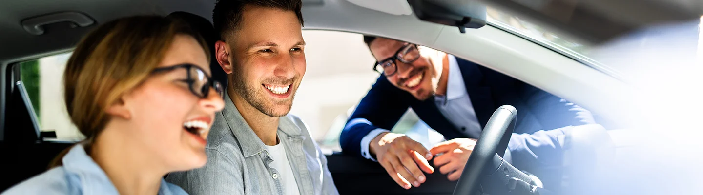 people checking out new car inside