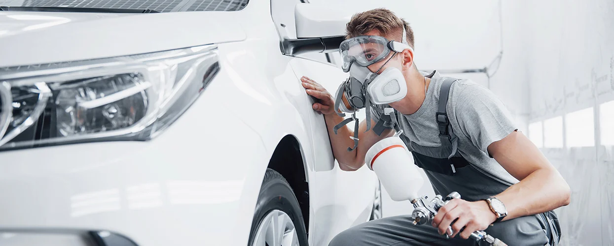 Service tech checking his paint spraying job