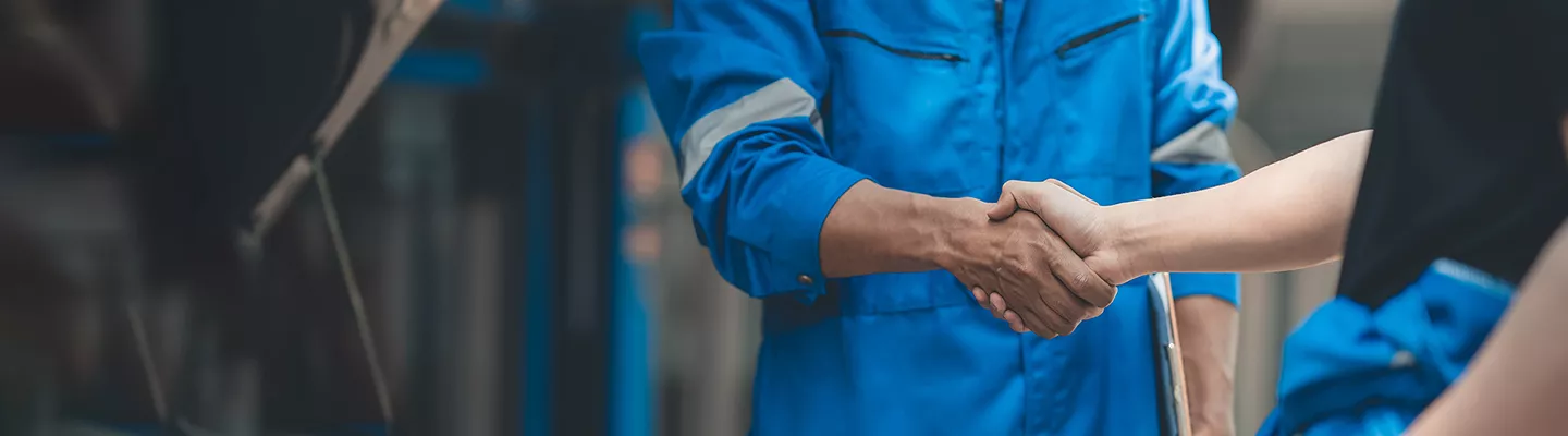 Mechanic shaking hands with a car owner