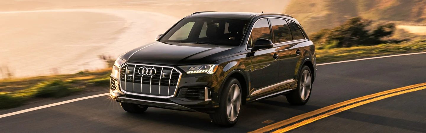 2024 Discovery vs Audi Q7 front side in brown