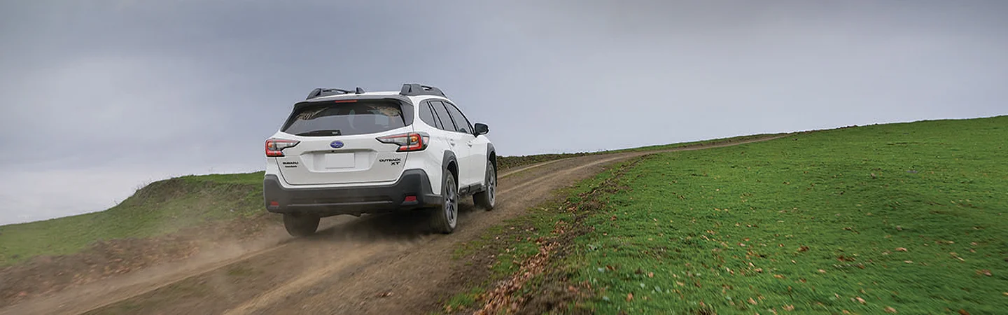 2025 Subaru Outback driving up a dirt road in Waco, TX