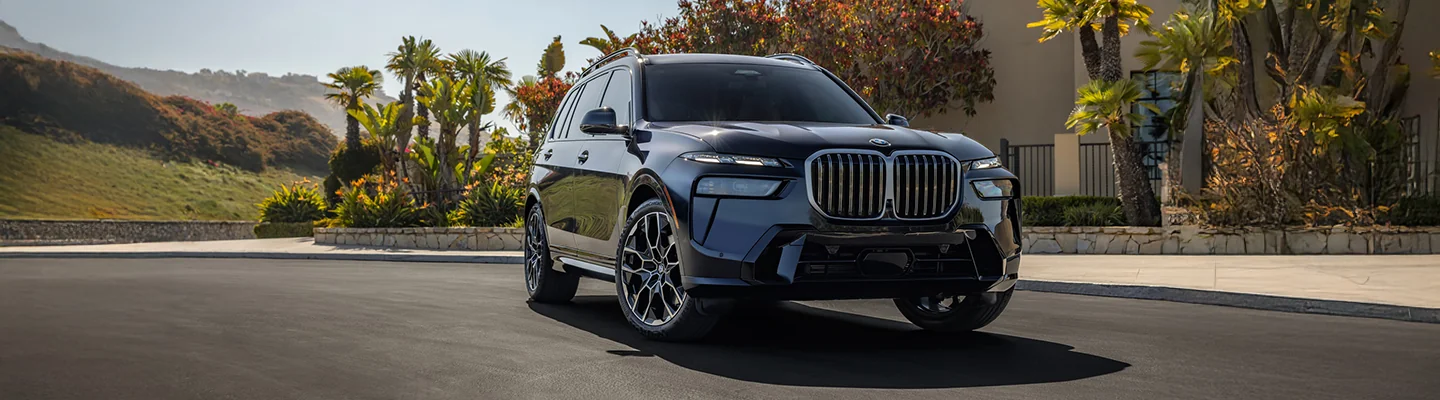Front view of a parked BMW SUV in front of a house
