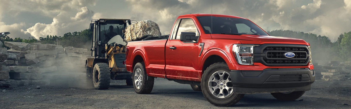 2023 Ford F-150 hauling piece of machine equipment