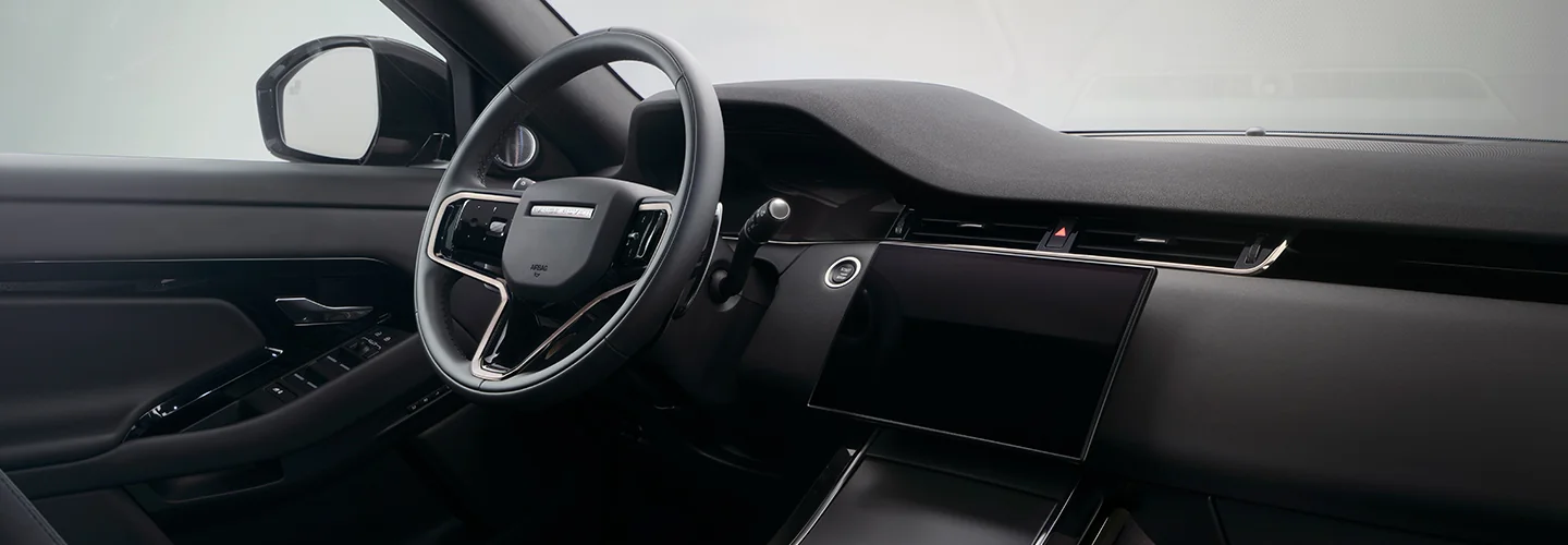 Interior view of the dashboard and front seat of a 2025 Range Rover Evoque