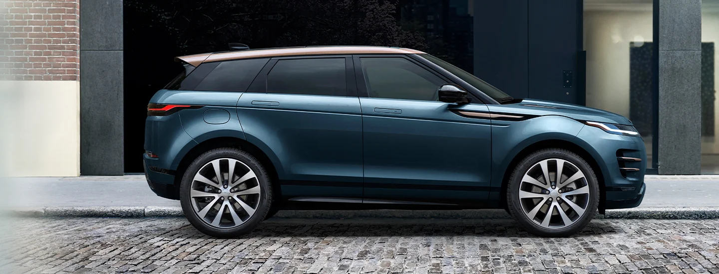 Side view of a parked 2025 Range Rover Evoque on a city street