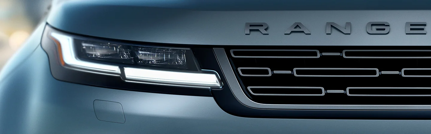 Close up view of the grill and headlight of a 2025 Range Rover Evoque