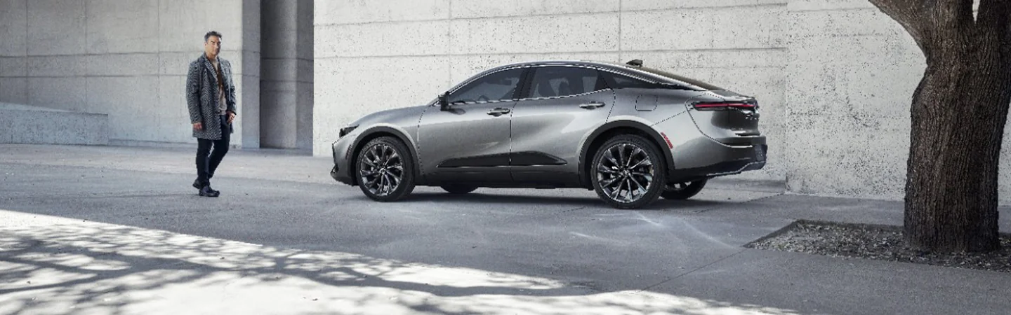 Side view of a gray 2025 Toyota Crown parked next to a building