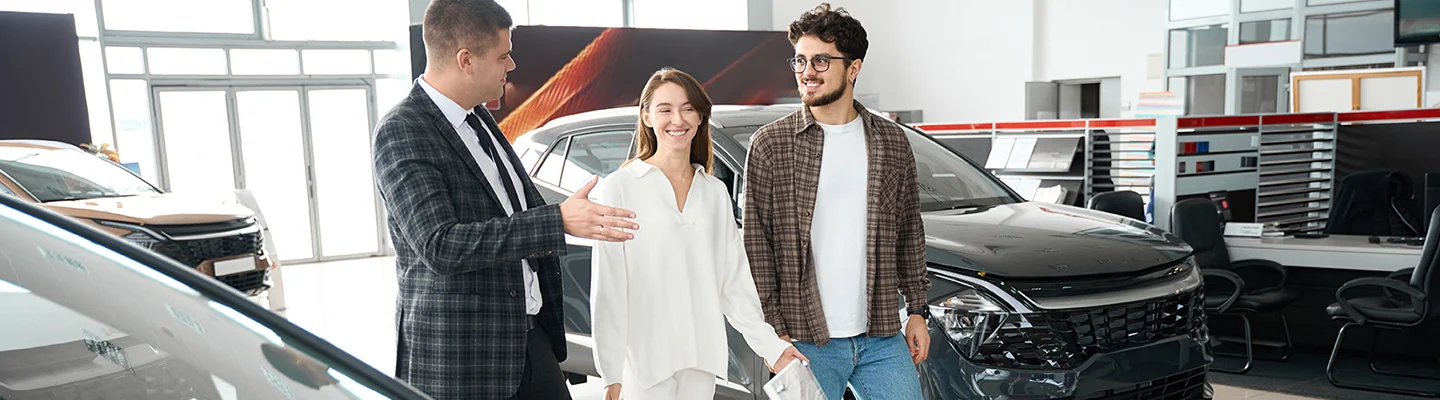 Couple discussing car purhcase with salesperson