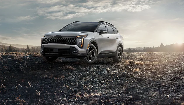 front view of a white Lifetime Kia vehicle parked in field