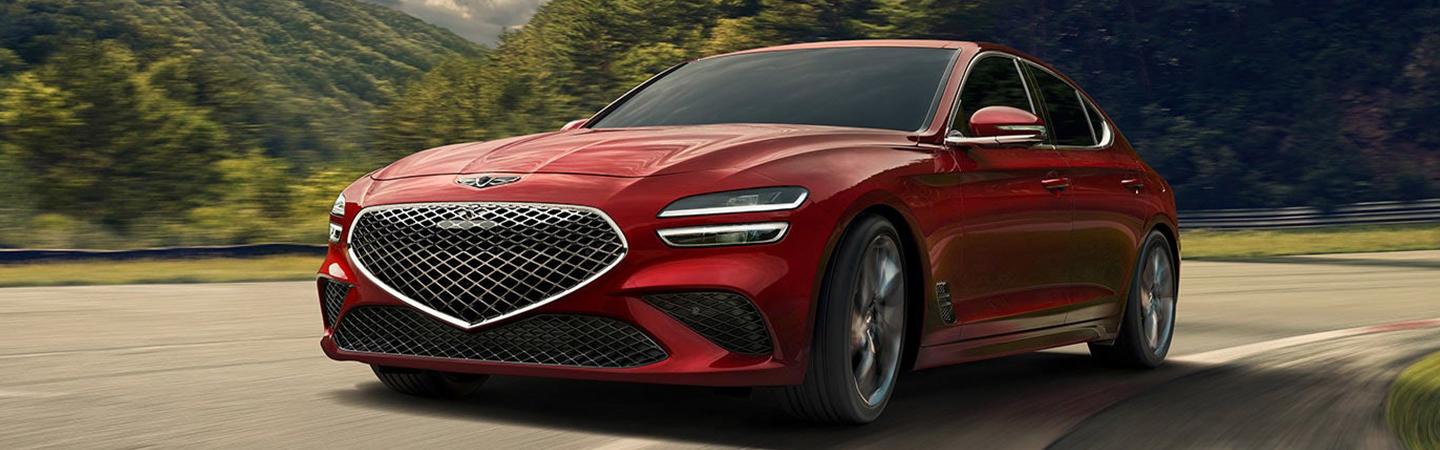 Red 2022 Genesis G70 taking a corner in motion
