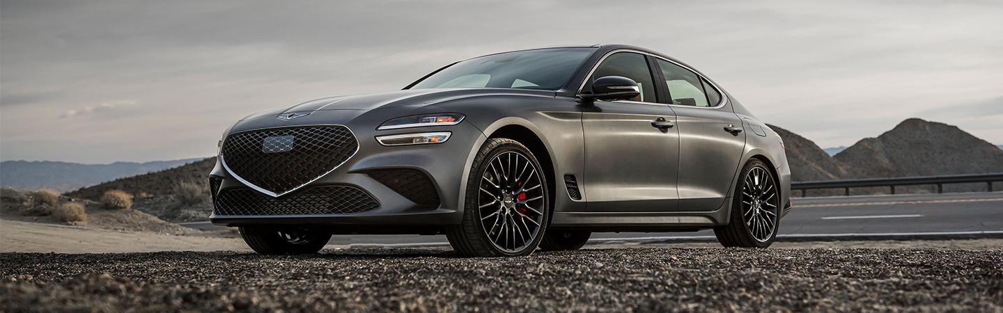 Silver 2022 Genesis G70 parked at scenic overlook in mountians