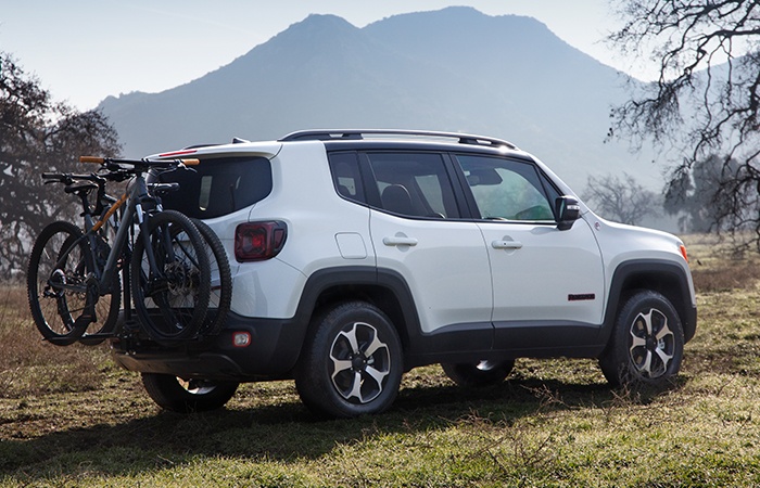 : A white Jeep Renegade with a bike rack