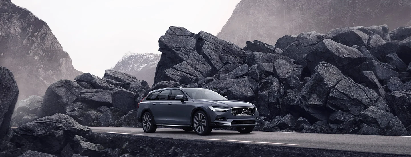 a silver 2025 Volvo V90 Cross Country on a cliff road