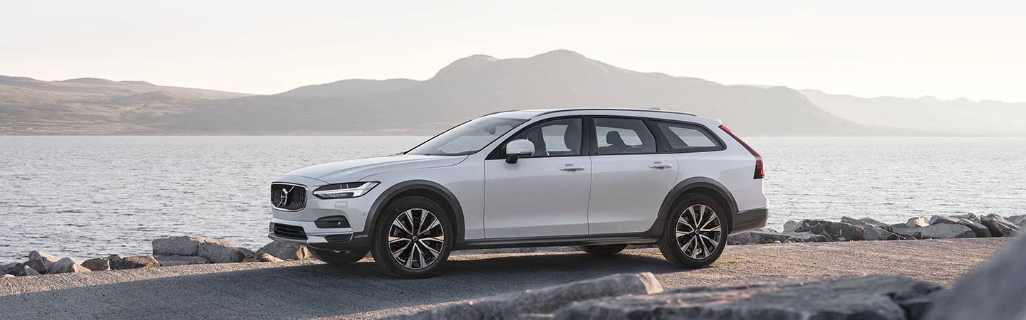 white 2025 Volvo V90 Cross Country Plus parked by shore