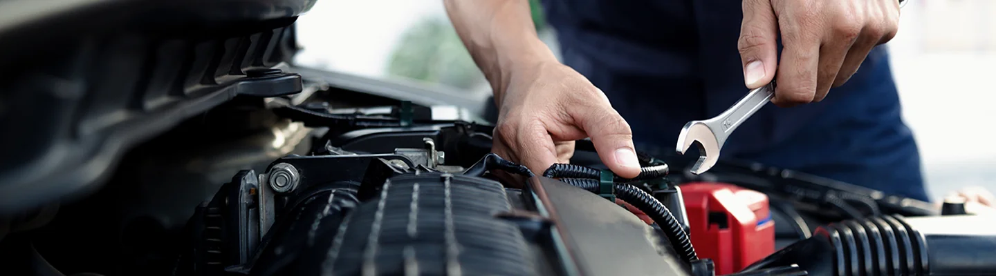 BMW service tech preforming engine maintance
