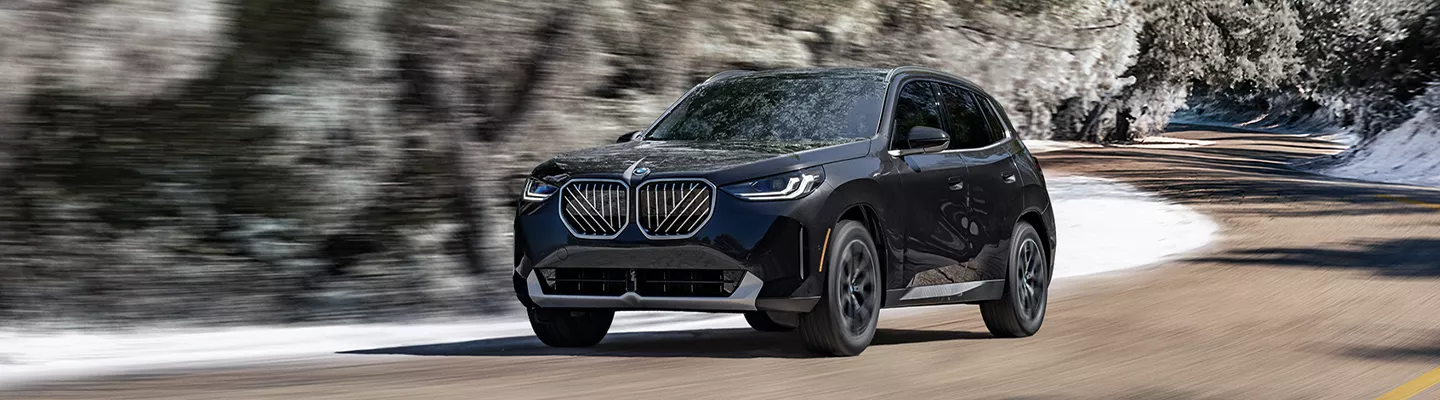 2026 BMW X3 driving down the road