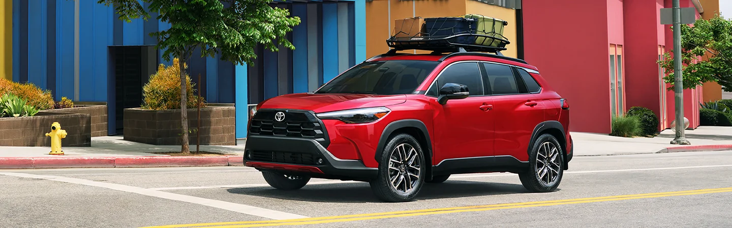 side view of a red 2026 Toyota Corolla Cross L with a rack on top