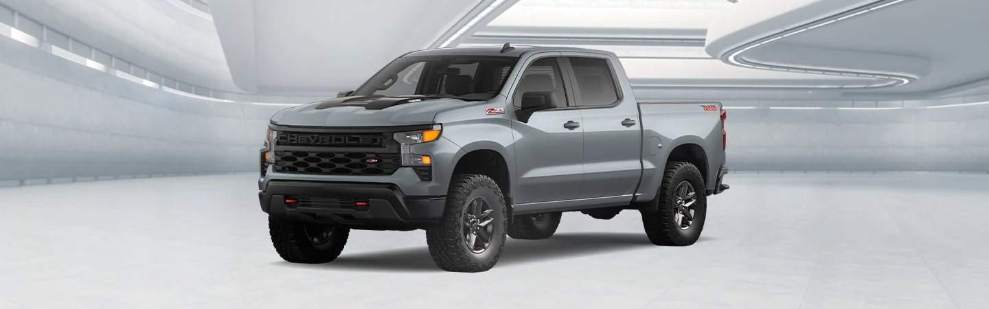 Front view of a gray 2025 Chevrolet Silverado 1500 in a white room