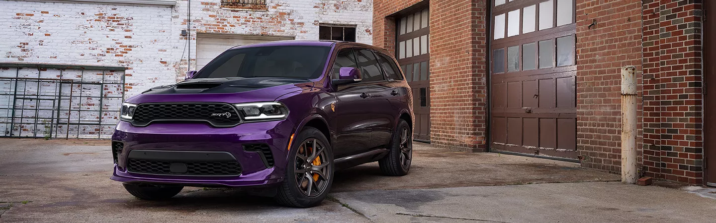 Purple 2026 Dodge Durango parked in front of a garage