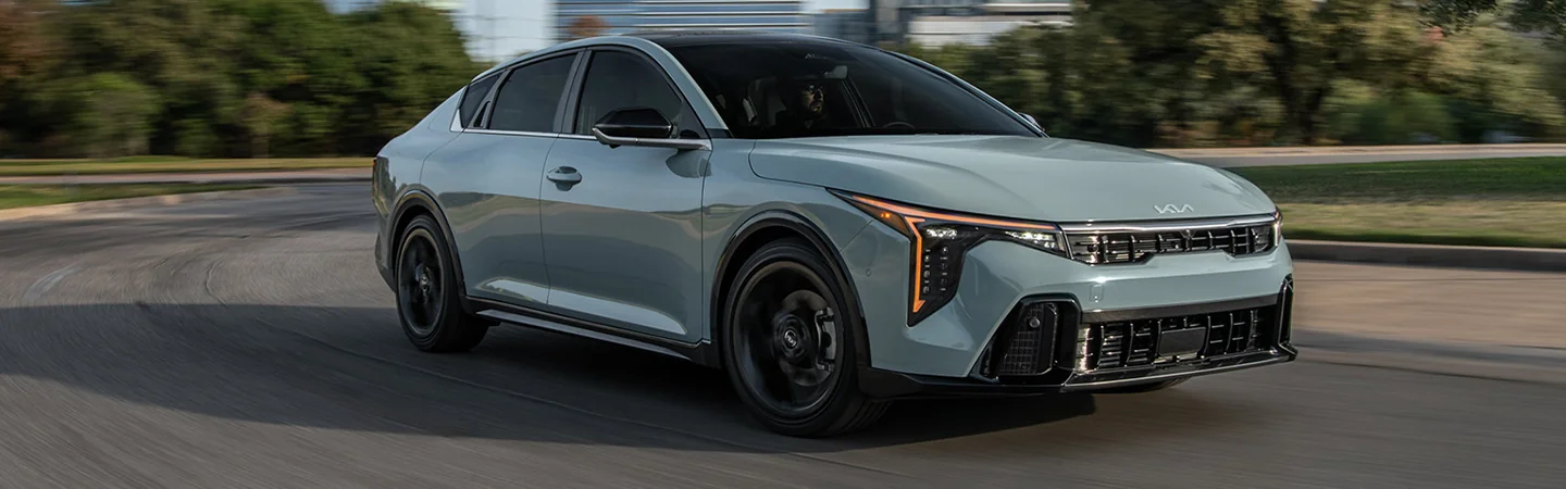 2025 Kia K4 Sliver color car on road Side view