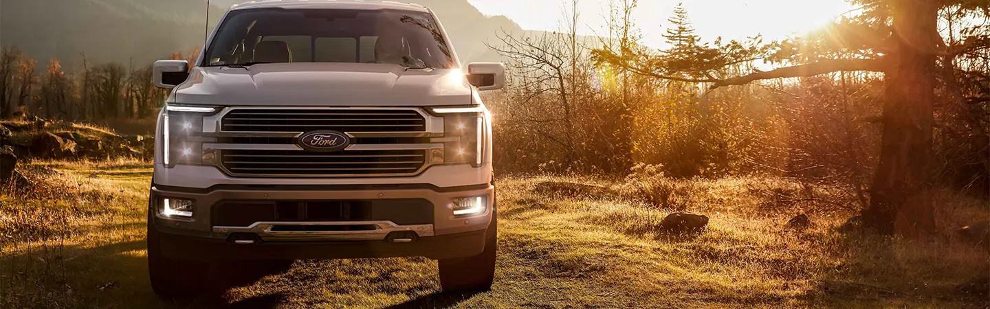 2024 Ford F-150 vs RAM 1500 front side view black