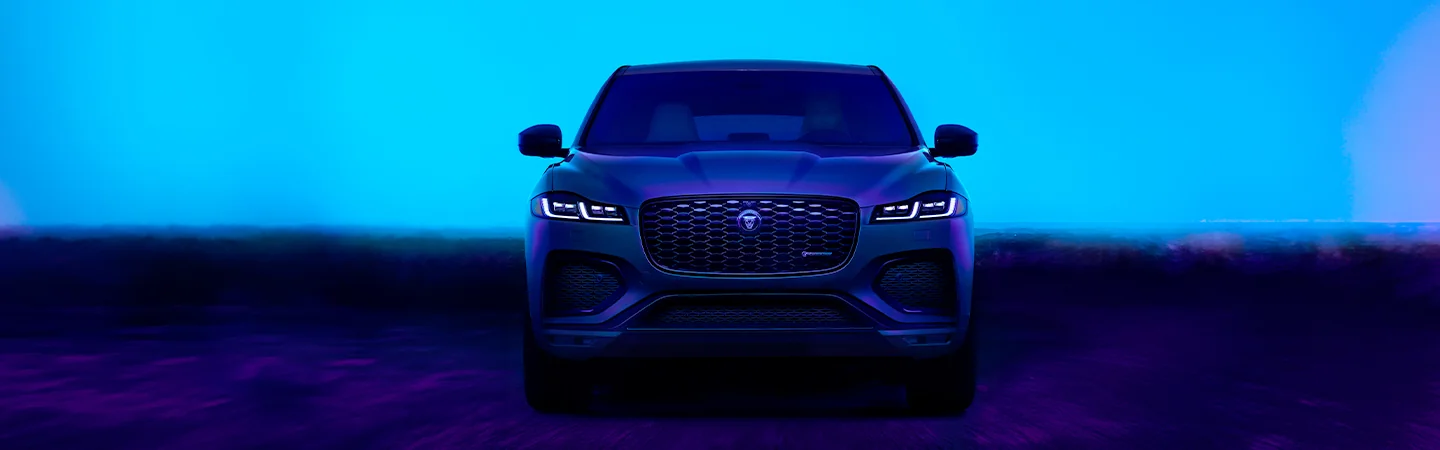Front view of a 2026 Jaguar F-PACE parked in front of a dark horizon