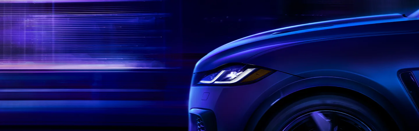 Front side view of a 2026 Jaguar F-PACE parked on a dark city street