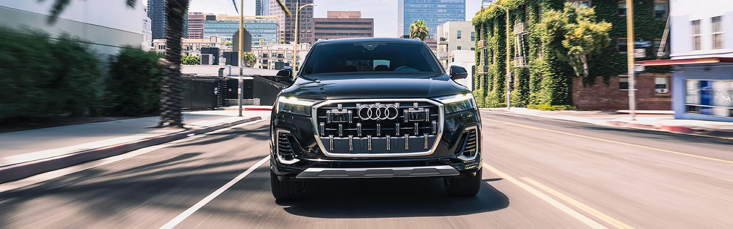 Fronbt view of a black 2025 Audi Q7 driving in the city
