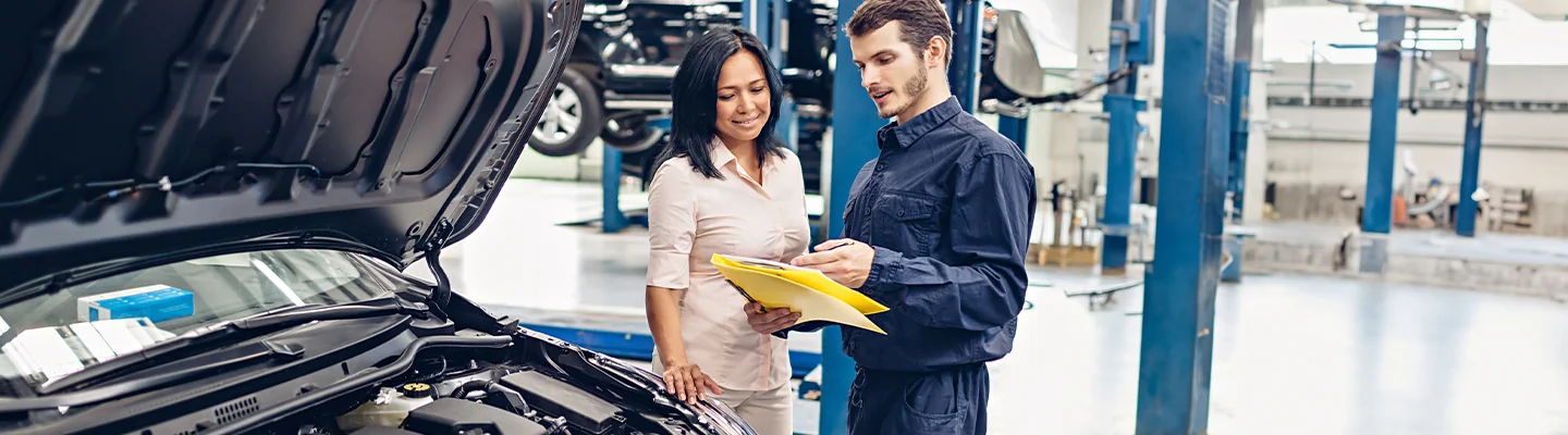 Car mechanic discussing reapir wioth customer