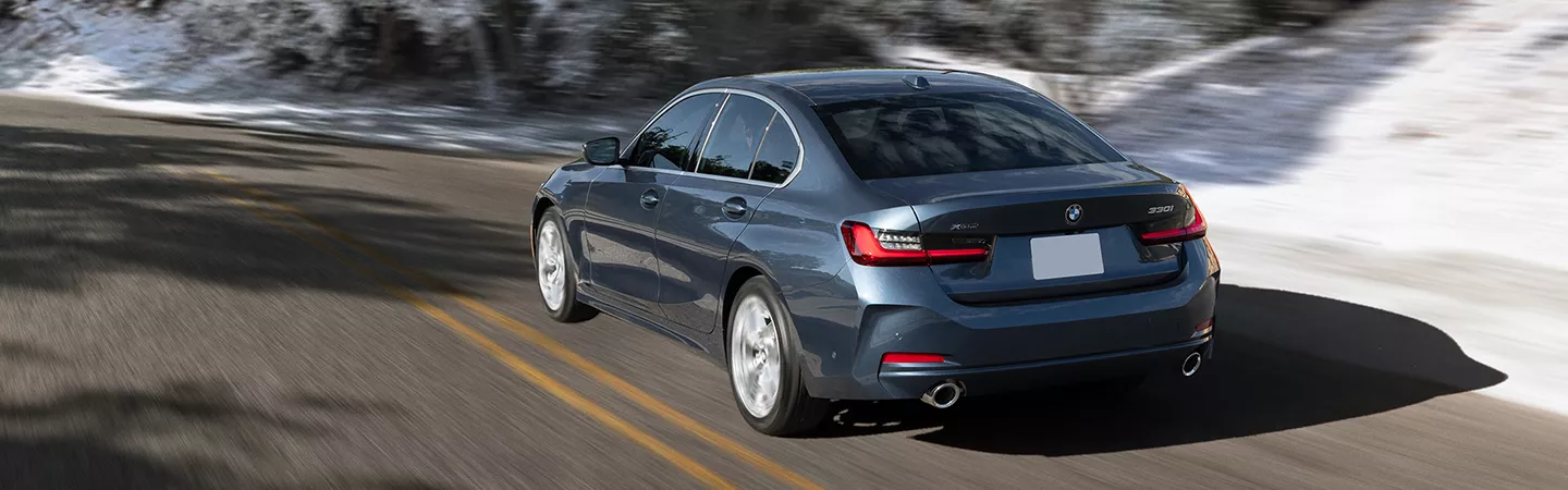 BMW 3 Series driving on a road 