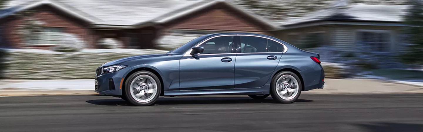 BMW 3 Series driving through a neighborhood