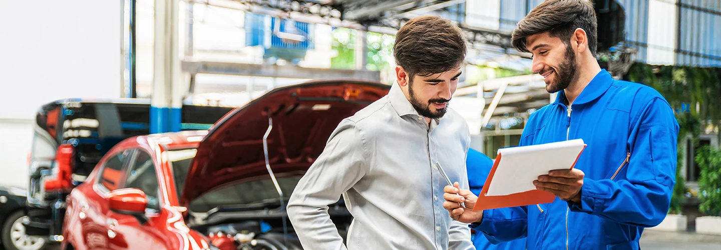 Service tech talking to service manager about car repairs