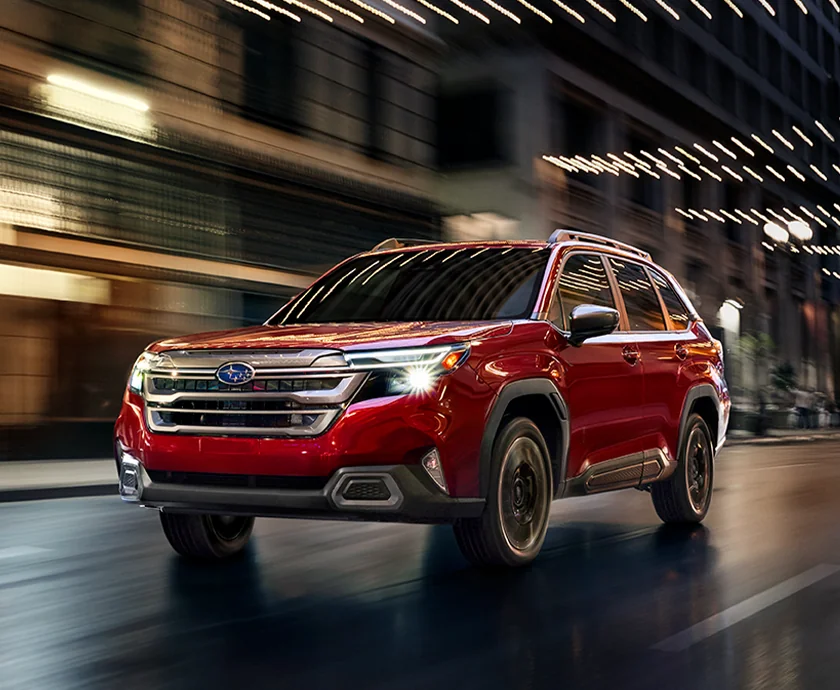 front view of a red 2026 Subaru Forester in motion
