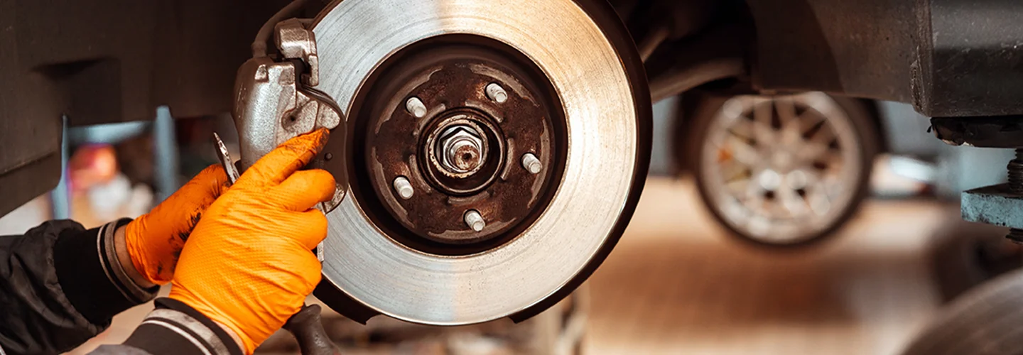 Service tech replacing brake pads