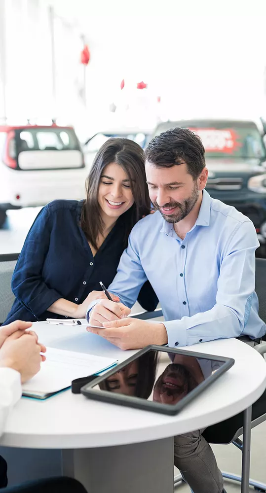 Customers reviewing vehicle financing information