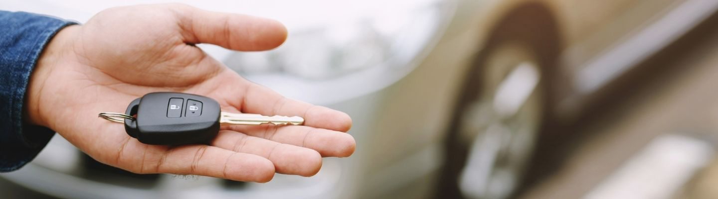 A car key being held