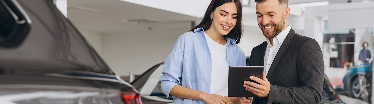 two people looking over whats included with a Kia Warranty and smiling