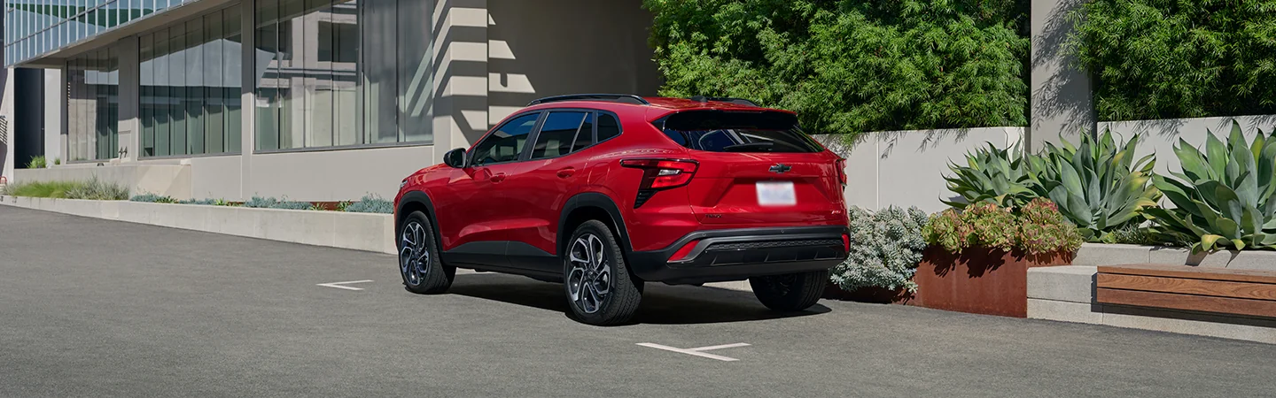 a rear view of a parked red 2026 Chevrolet Trax ACTIV