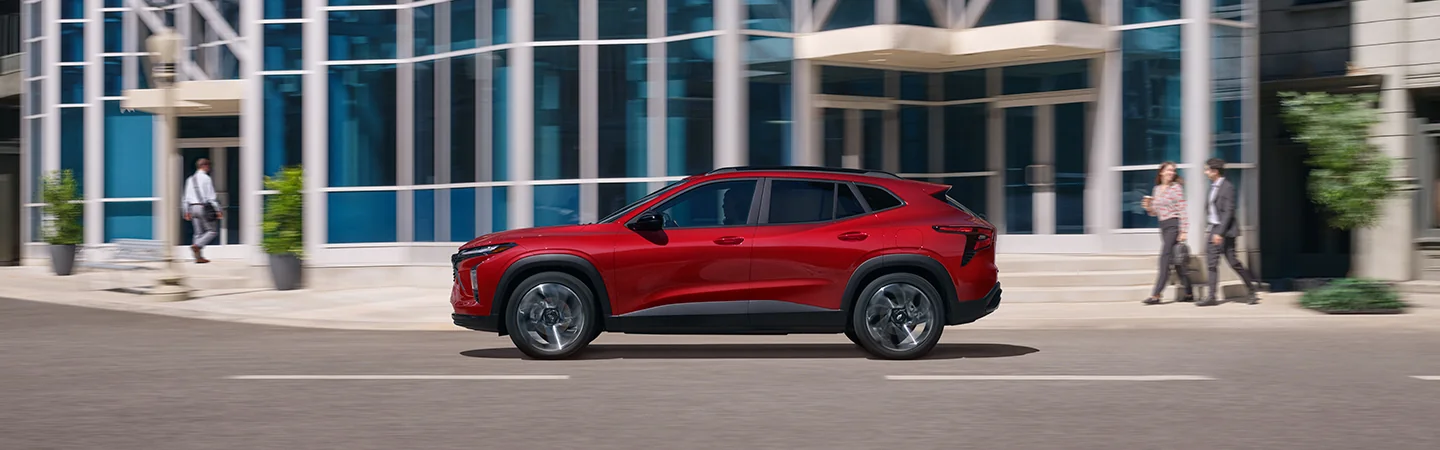 a side view of a parked red 2026 Chevrolet Trax ACTIV