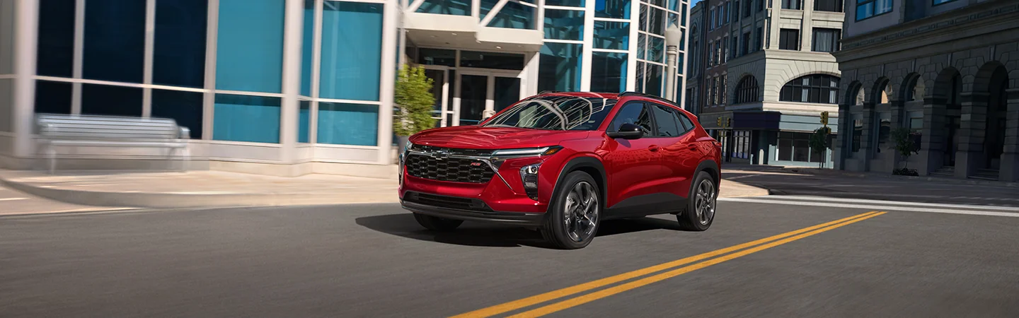 a side - front view of a parked red 2026 Chevrolet Trax ACTIV